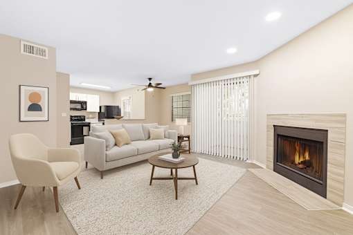 A living room with a fireplace and a ceiling fan.
