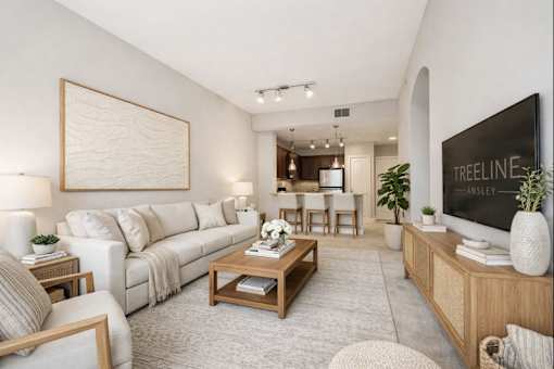 A living room with a couch, coffee table, and a large painting on the wall.