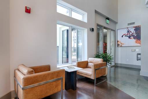 A waiting room with two chairs and a table.