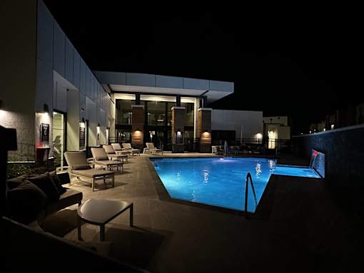 the pool is lit up at night at the ace hotel