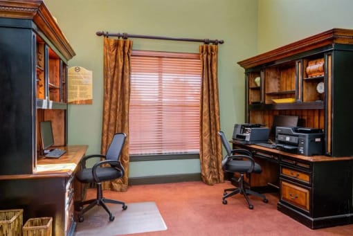 a home office with a desk and a window