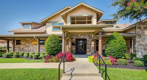 the front of a house with a walkway and stairs in front of it