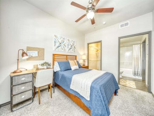 a bedroom with a bed and a ceiling fan