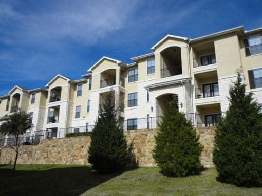an apartment building with trees in front of it