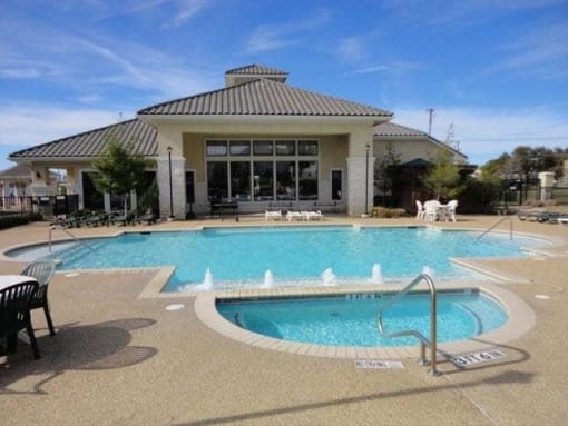 a swimming pool with a building in the background