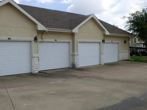 a house with three garage doors and a driveway