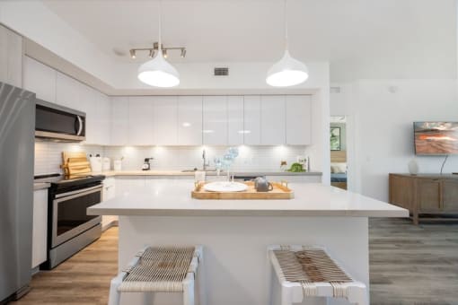 a kitchen with an island and a stove and a refrigerator