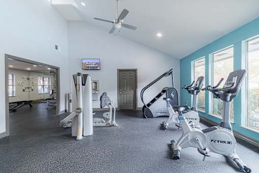 A spacious home gym with a variety of exercise equipment.