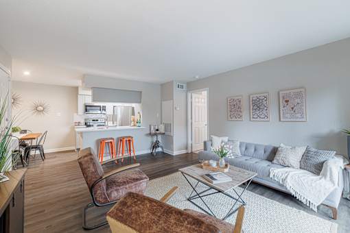 A living room with a grey couch and a brown chair.