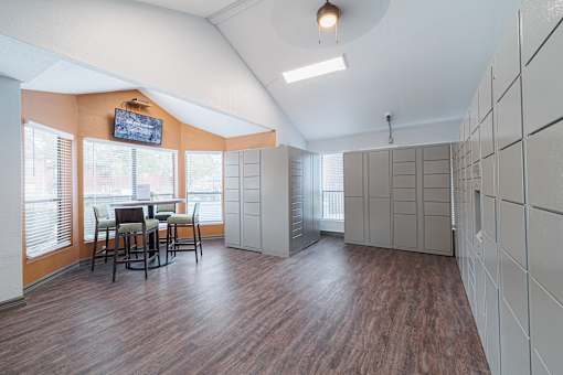 A room with wooden floors and a television mounted on the wall.