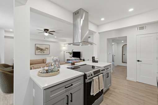 A modern kitchen with a large island and stainless steel appliances.