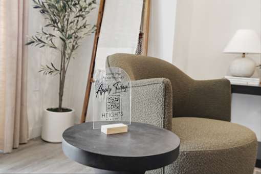 A chair with a sign that says "Happy New Year" is in front of a plant.