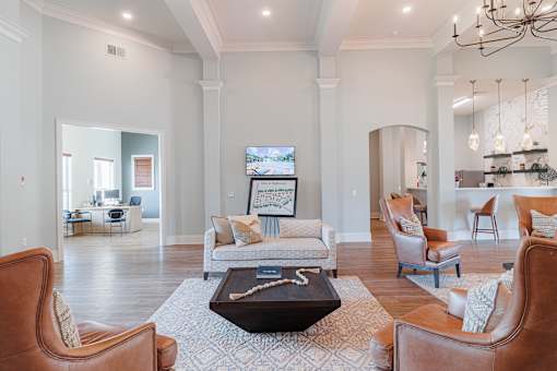 A living room with a brown leather chair and a coffee table in the center.