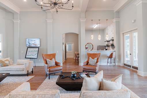 A living room with a chandelier, couches, and a coffee table.