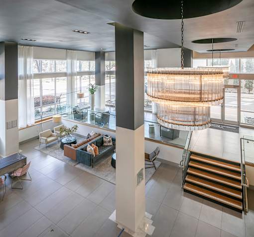 A large, open space with a hanging light fixture and a staircase.