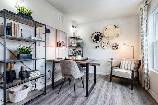 A modern dining room with a wooden table and chairs.