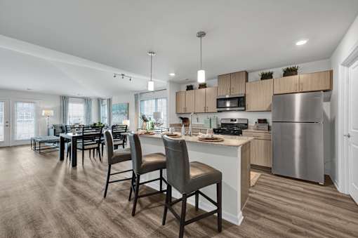 A modern kitchen with a dining table and chairs.