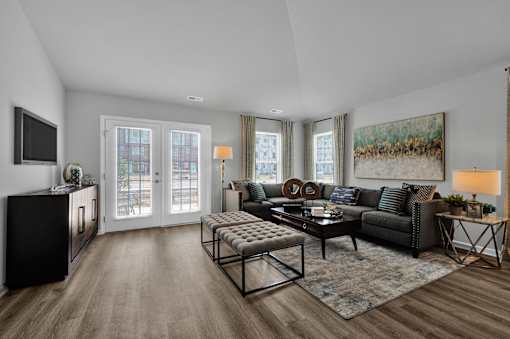A modern living room with a grey sofa and a coffee table.