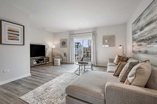A living room with a grey couch and a television.