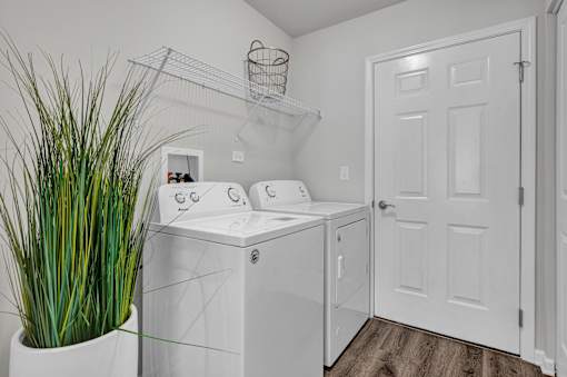 A white washer and dryer in a laundry room.