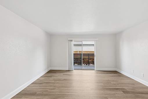 A room with wooden floors and white walls.