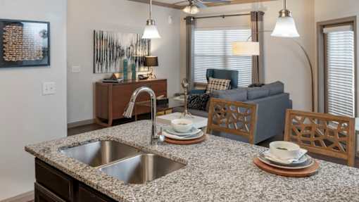 A kitchen with a granite countertop and a sink.