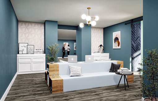 A modern office space with a reception desk and two people standing in the background.