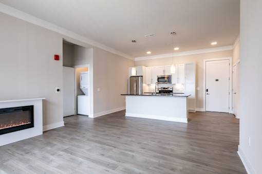 A modern kitchen with a fireplace and a bar area.
