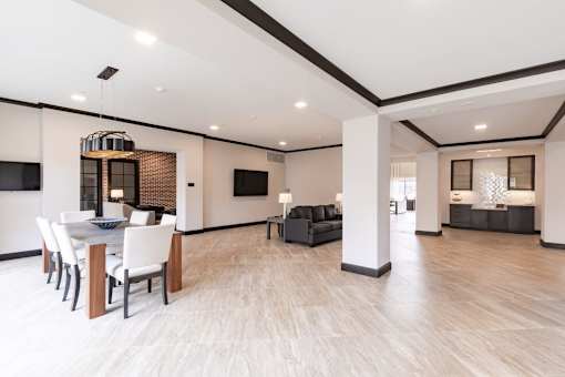 A modern living room with a dining table and chairs.