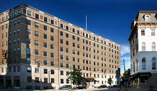 A large building with a lot of windows is in the foreground.