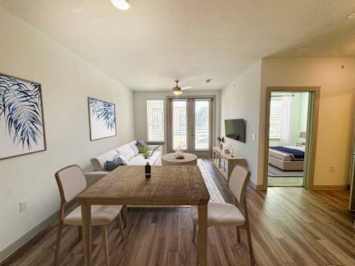 A dining room with a wooden table and chairs.