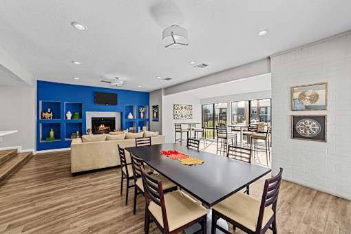 A modern dining room with a black table and chairs.