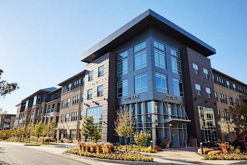 A modern building with a glass facade and a sign that reads "FRIENDLY".