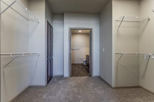 a walk in closet in a bedroom plus den unit at the casey, 2100 delgan
