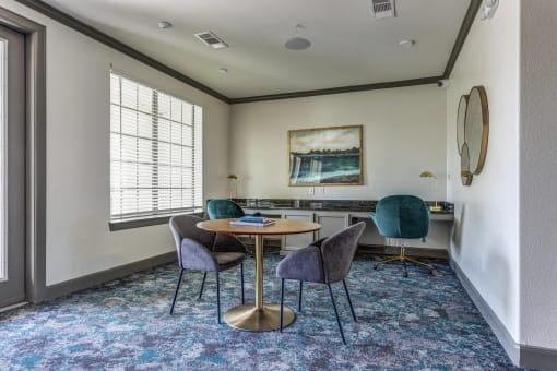 a meeting room with a table and chairs
