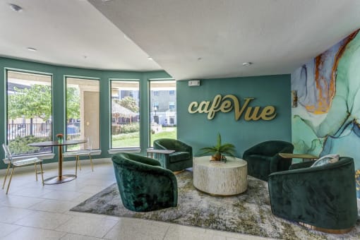 a lobby with green chairs and a green wall with the words café vue on it