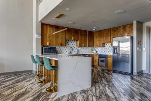 a kitchen with wooden cabinets and a white marble counter top