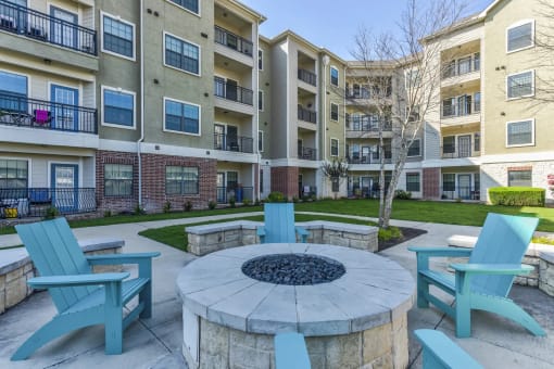 an outdoor firepit and lounge area at the bradley braddock road station apartments