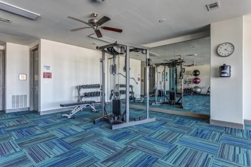 a fitness center with weights machines and mirrors