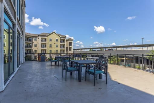 a patio with tables and chairs at the bradley braddock road station apartments