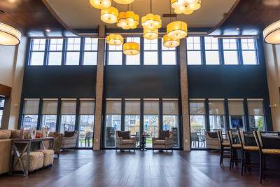 A large room with wooden floors and a long table with chairs.