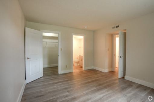 a living room with a hard wood floor and white doors