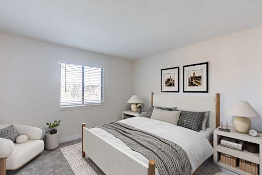 A bedroom with a bed, nightstand, and chair.