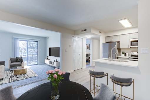 A modern living room with a black table and grey chairs.