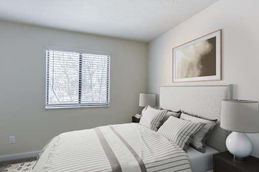 A bedroom with a large bed and a painting on the wall.