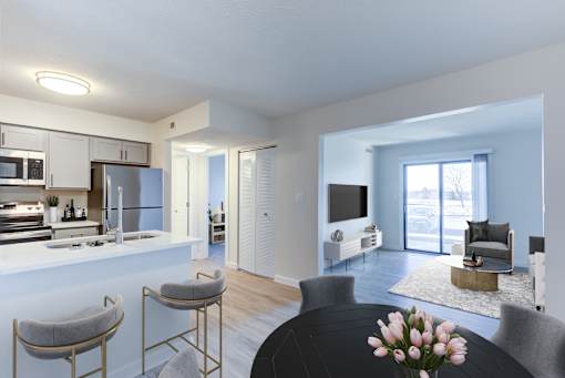A modern kitchen with a breakfast bar and a dining area.