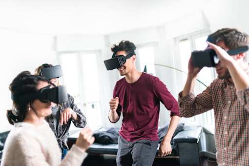 People wearing virtual reality headsets in a room.