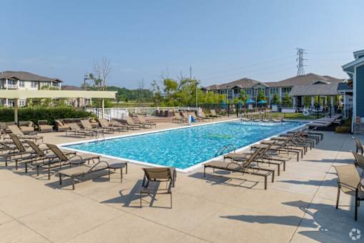 A large swimming pool surrounded by lounge chairs.
