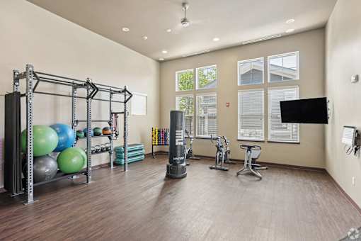 A spacious home gym with a variety of exercise equipment.