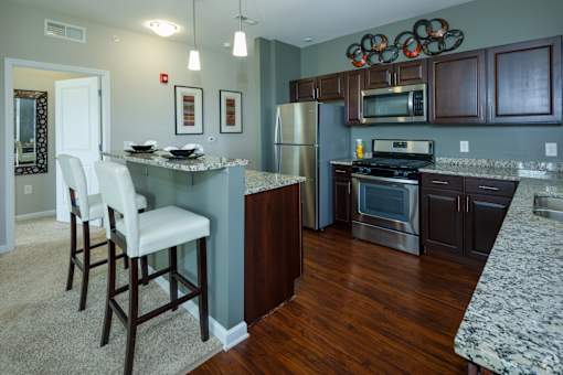 A kitchen with a table and chairs.